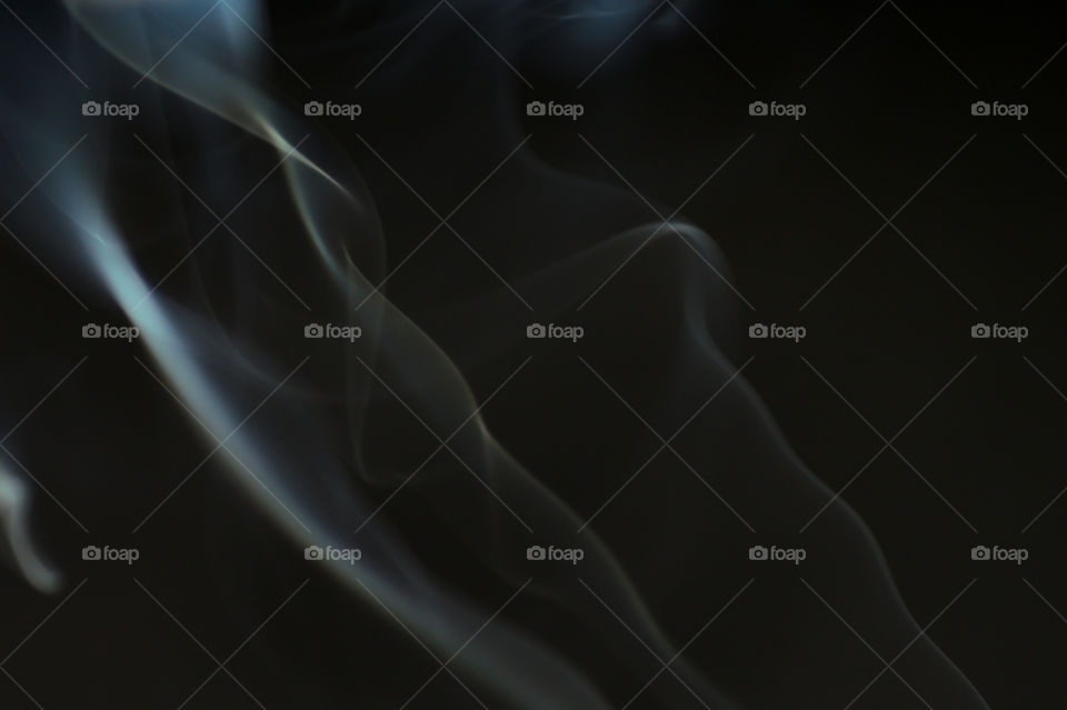 Smoke scented candles on a black background