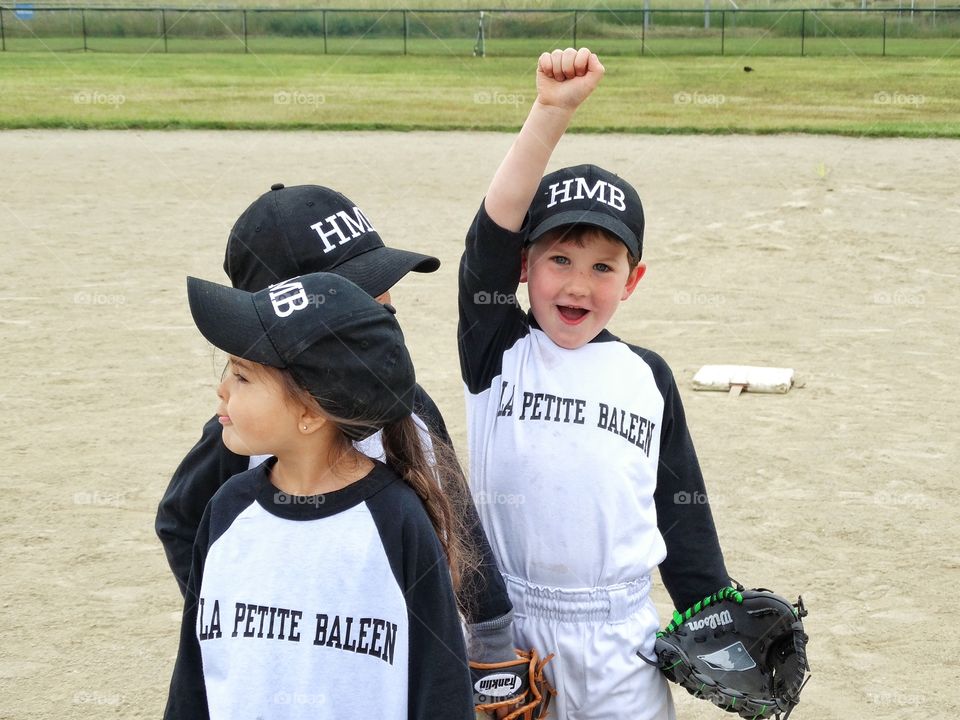 Proud Young Baseball Player. Little Boy Smiling With a Pride After Winning A Baseball Game
