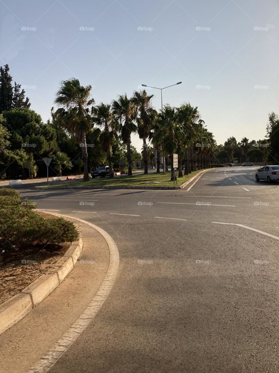Empty streets in the sunny kusadasi Turkey. Palms and empty roads. Summertime photo. Holidays adventure.