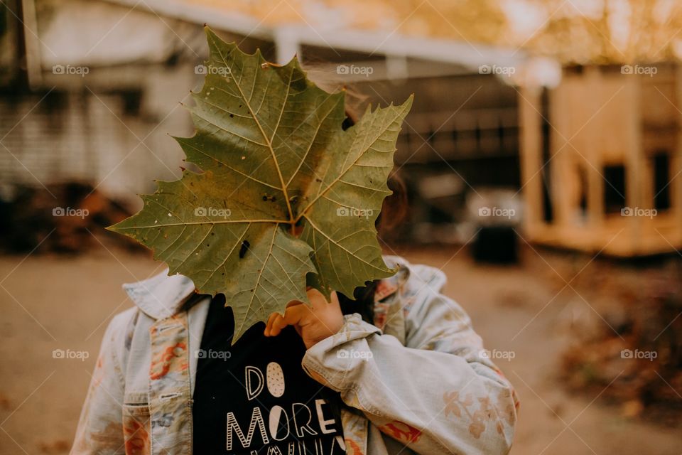 Girl holding big leaf 