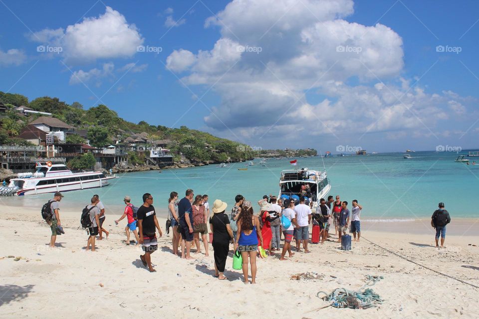 Crowds gather near "arrival and departure" coastline area of Nusa Lembongan island near Bali, Indonesia. 