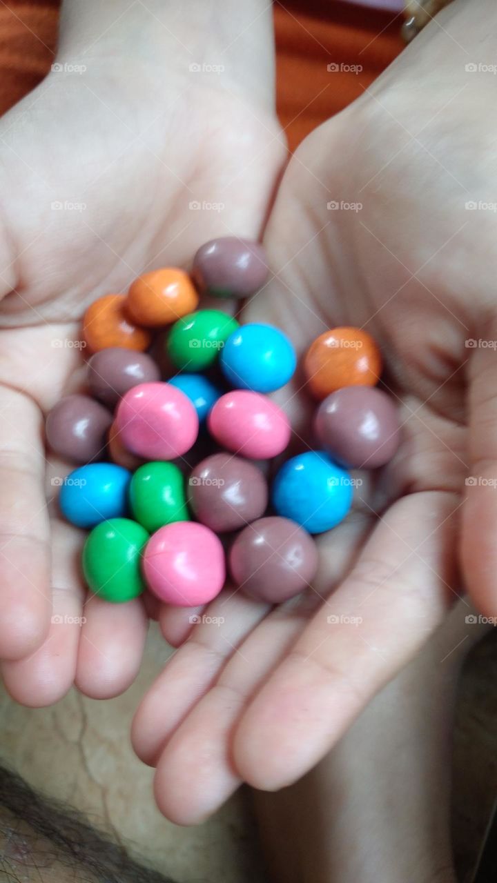 Colorful candy in the palm of the hand