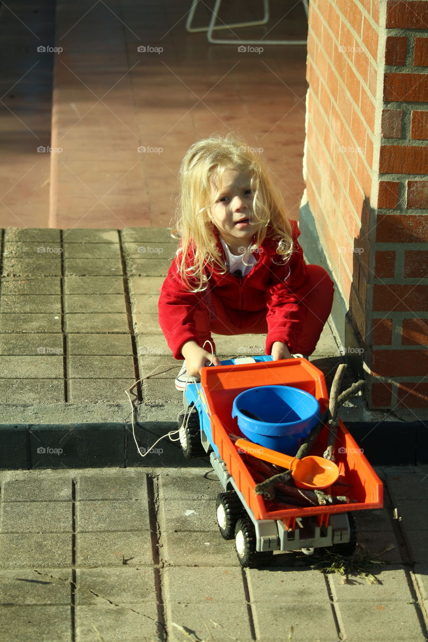 girl playing with carreril