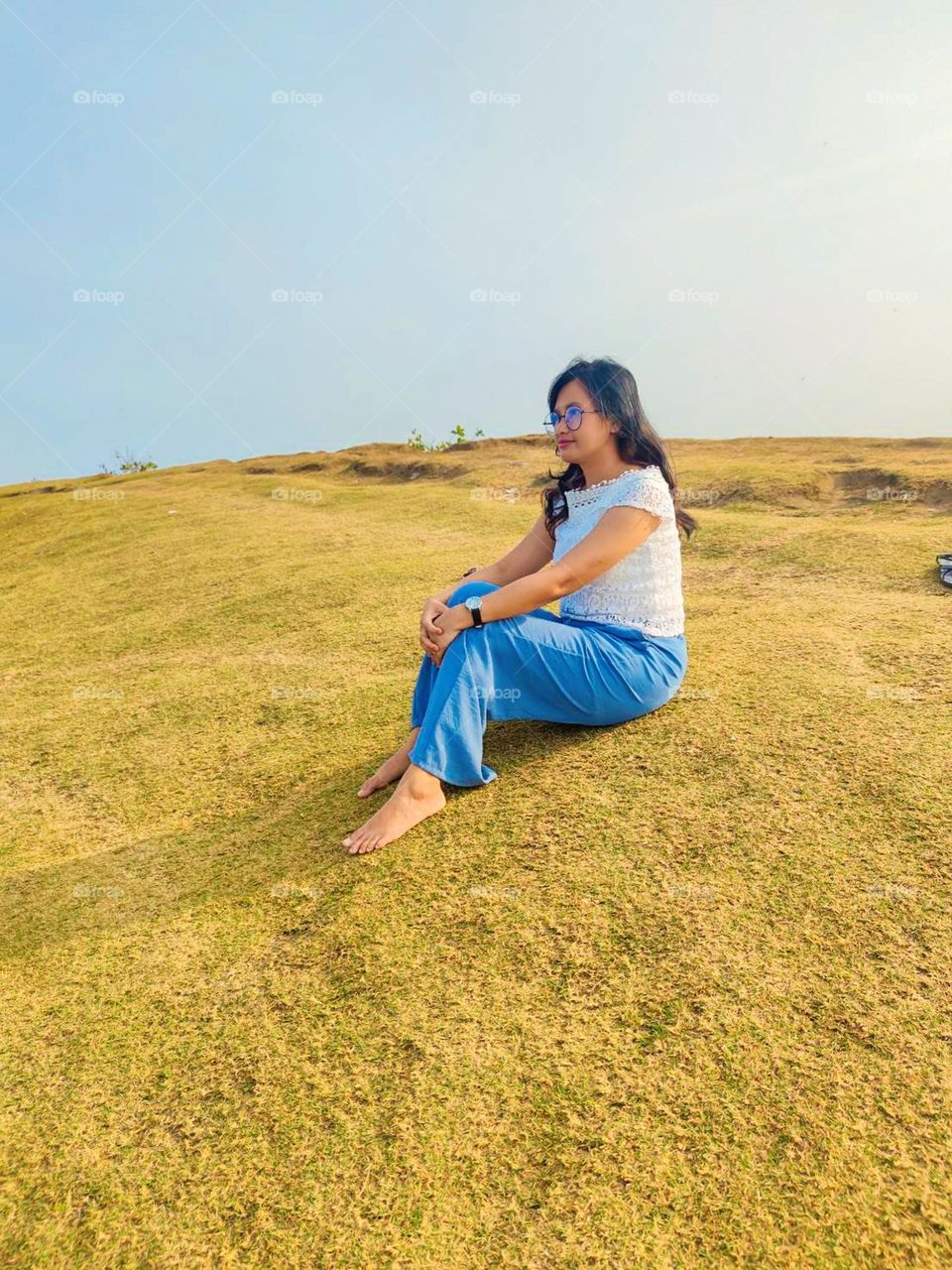 Portrait of young woman on holiday in the meadow during the day