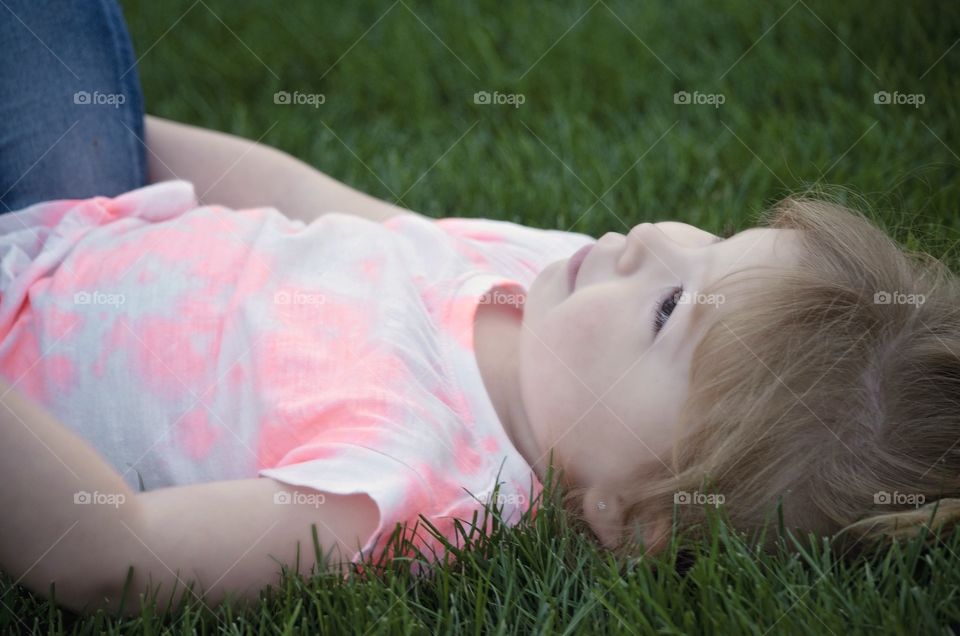 Cute girl lying on grass