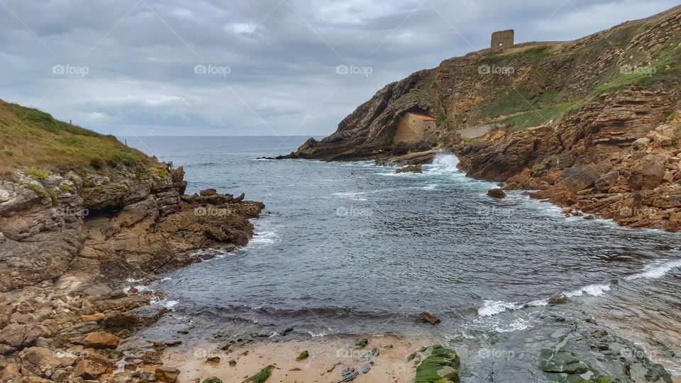 View of Santa Justa beach and Chapel of Santa Justa, Cantabria, Spain.