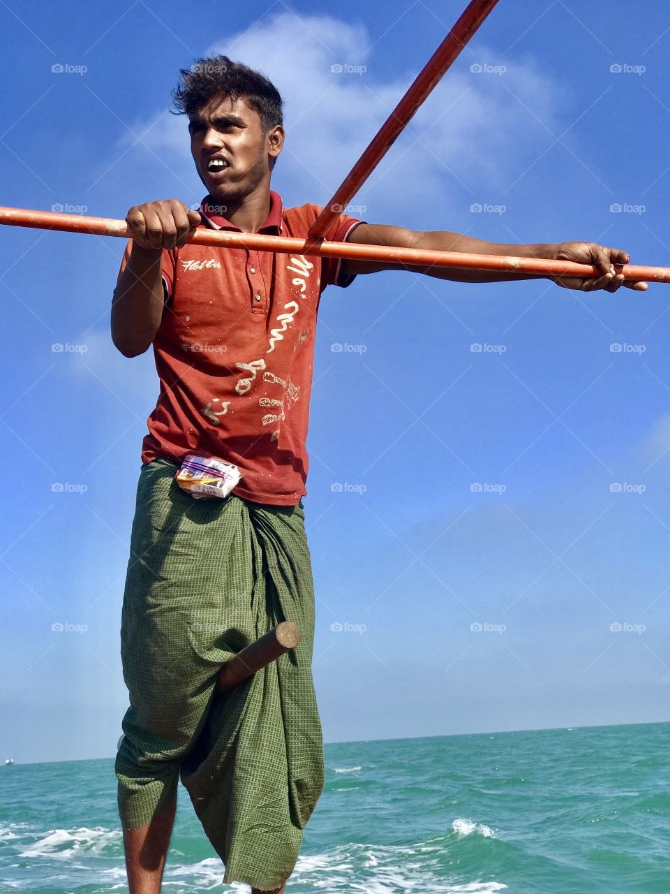 A boat man are driving his boat on the sea, have no fear no tension. He directs the boat for the destination only by his two legs , really a awesome moment to watch !