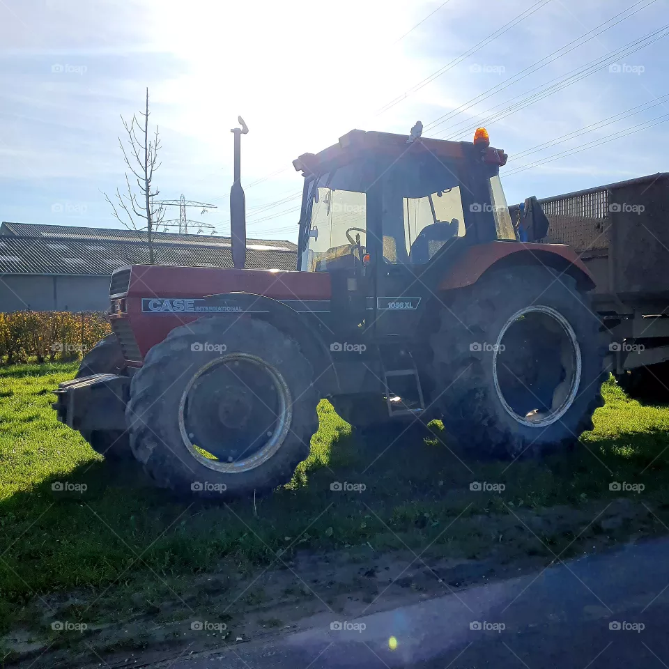 Tractor outside in the sunshine.