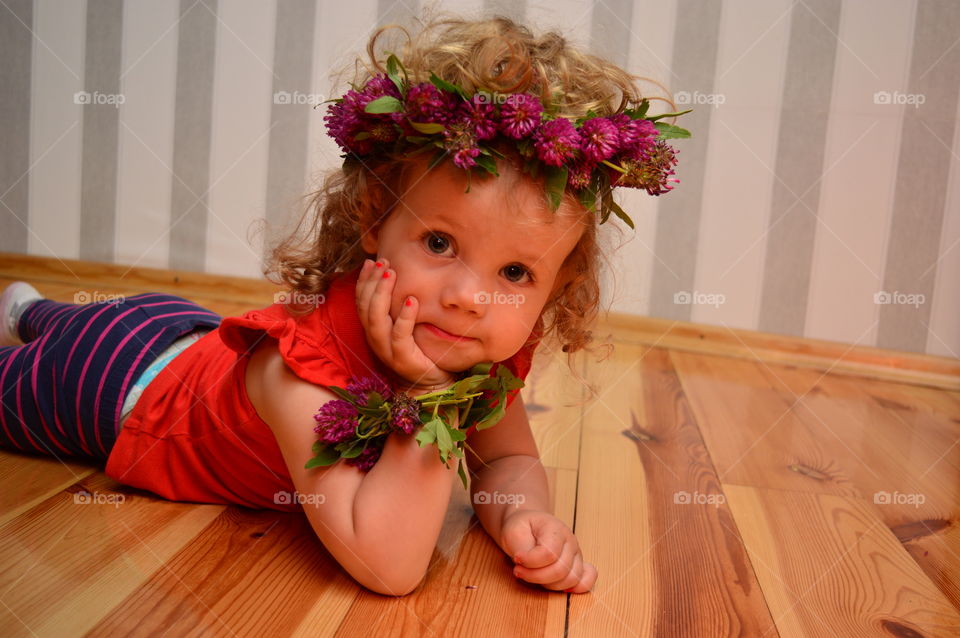 Little girl lying on floor in house