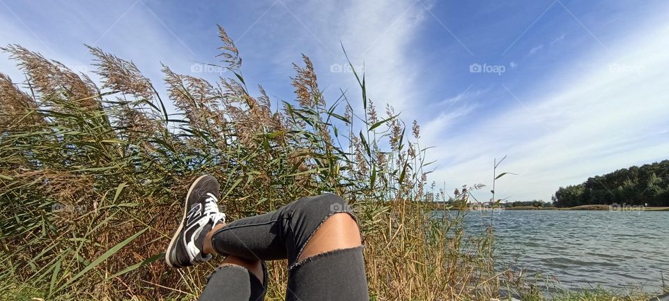 woman meditation female legs blue sky clouds outside