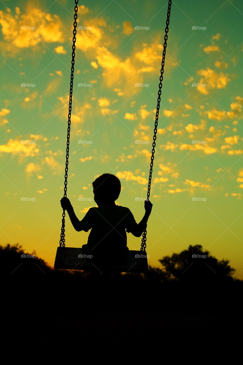 kid on hammock. playing With hammock at sunset