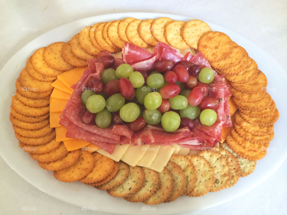 Crackers, meat, fruit and cheese platter