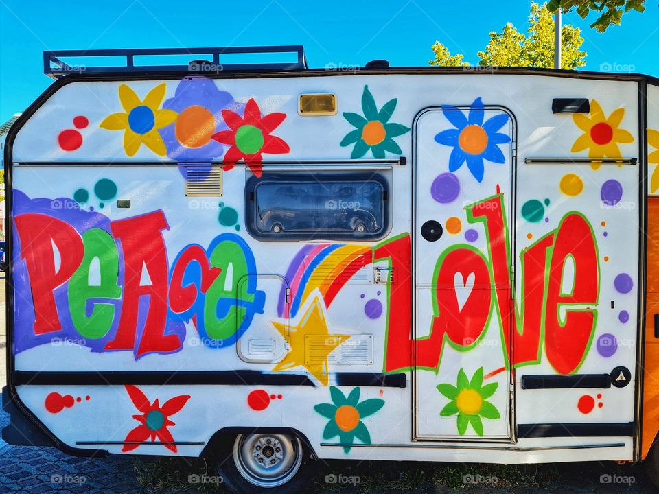 whimsical and colorful camper with a hymn to peace and love designed