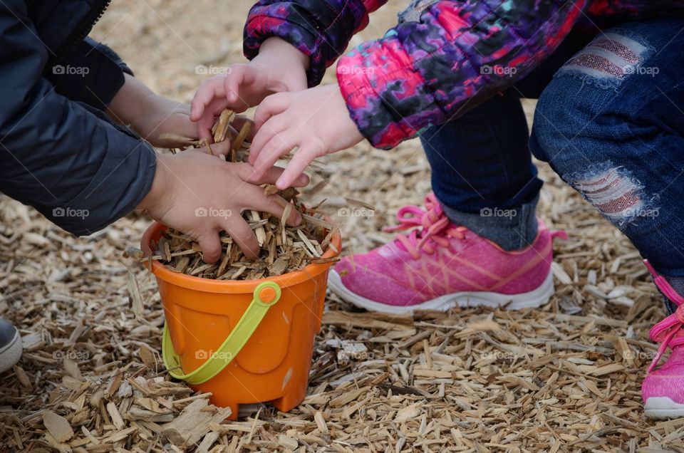 Childrens playing with a wood shaving