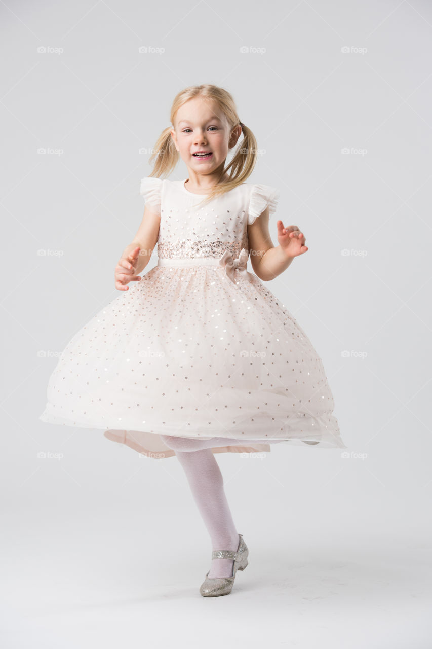 6 year old child model posing in a studio.