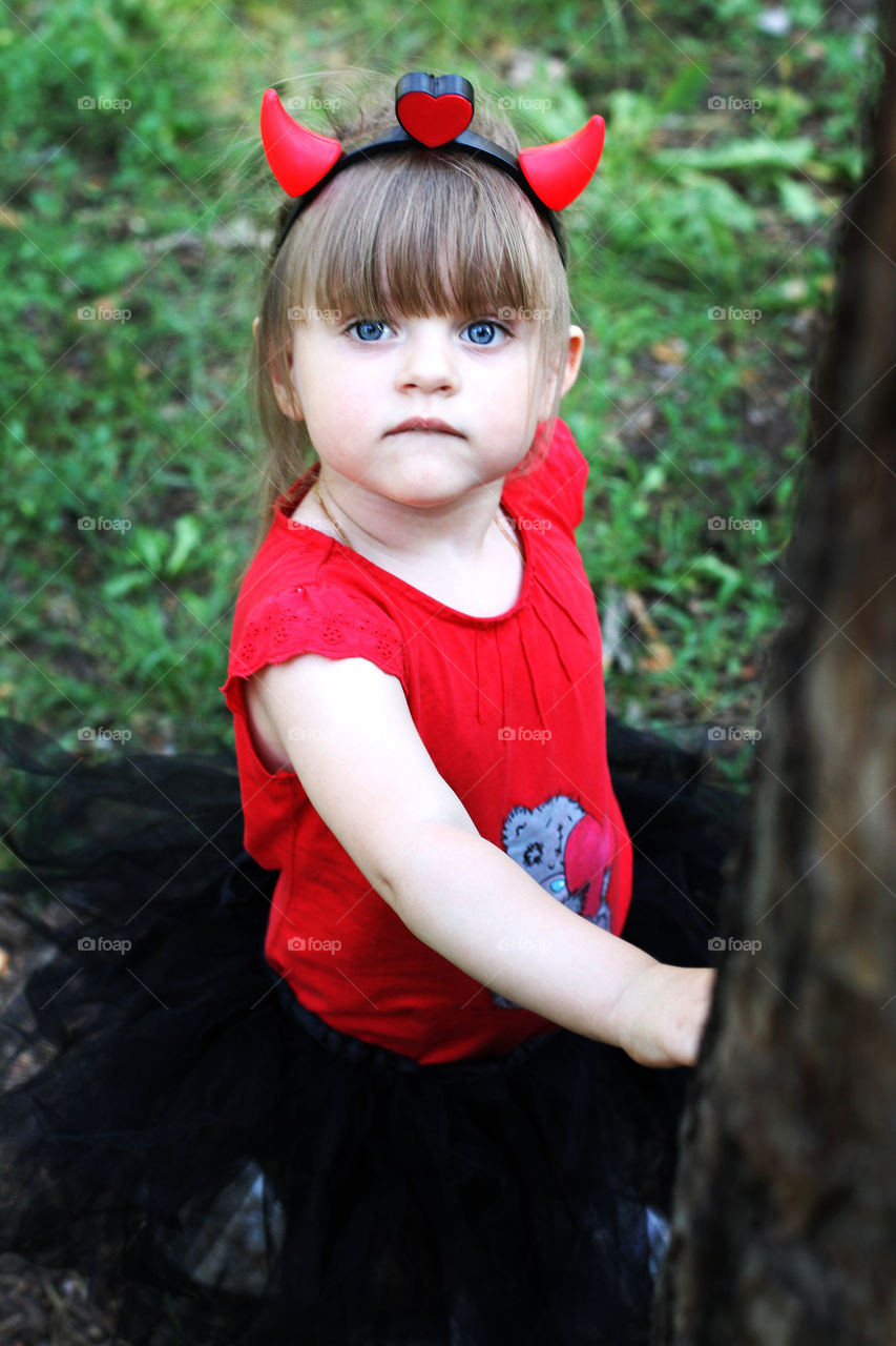 Close-up of a girl wearing horn hairband