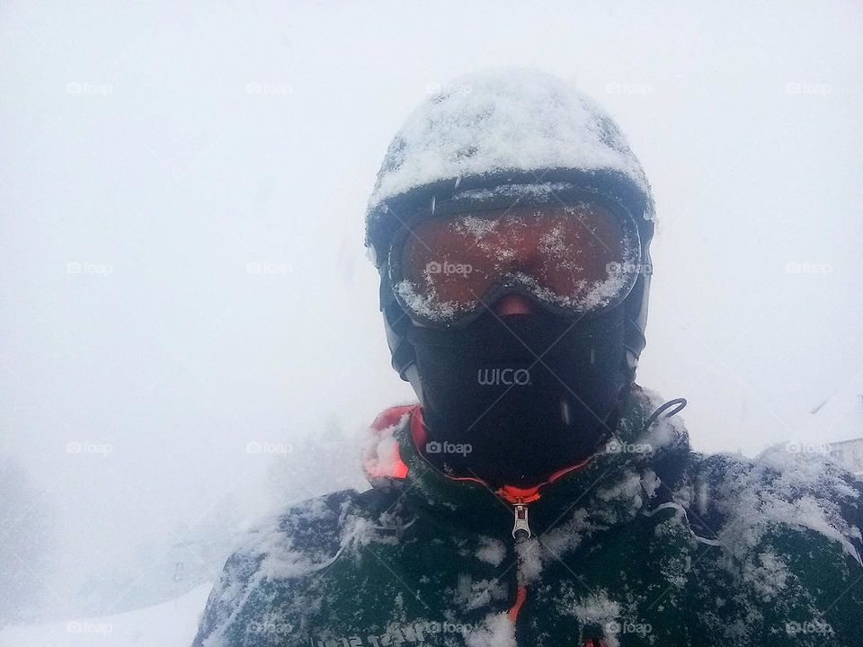 Life in motion.  Snowfall.  A man in alpine skiing equipment.  Sports and free time.