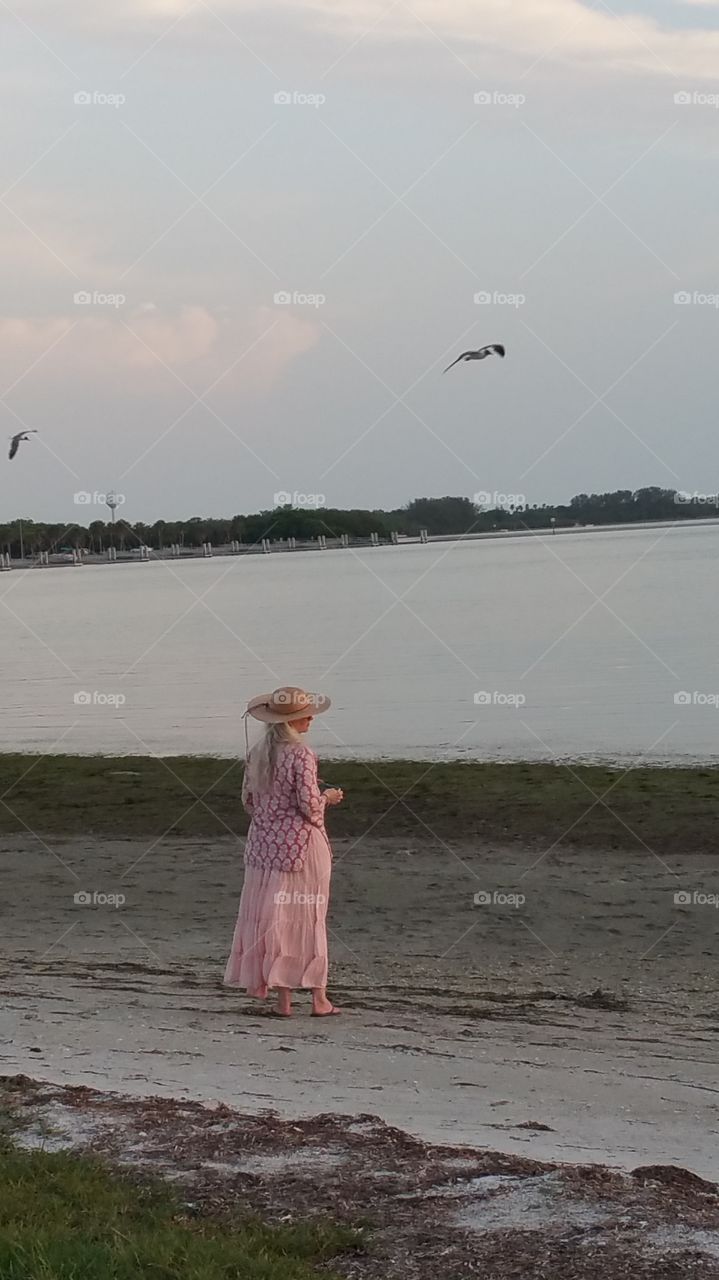 Bird watcher. Beautiful dressed woman watching the birds.