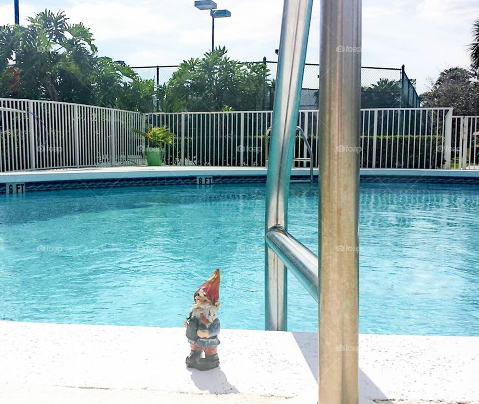 Gnome at the pool. Traveling Gnome visits the pool