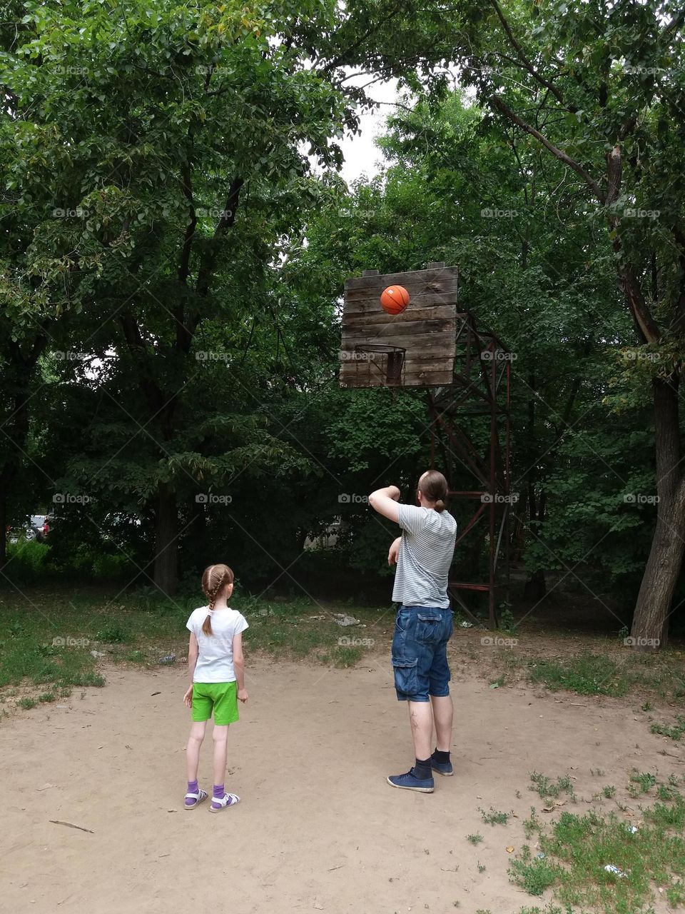 Father and daughter playing basketball