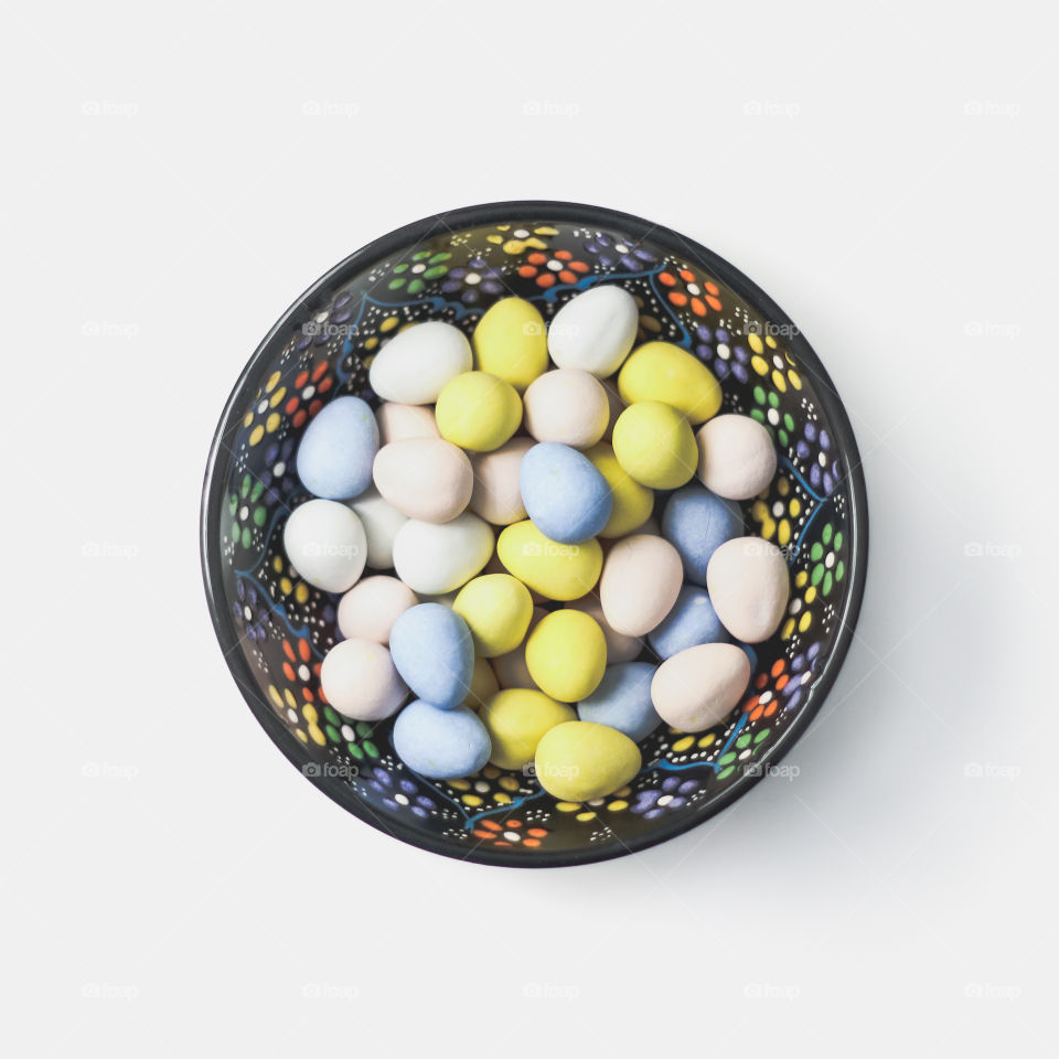 Colorful bowl with colourful chocolate eggs
