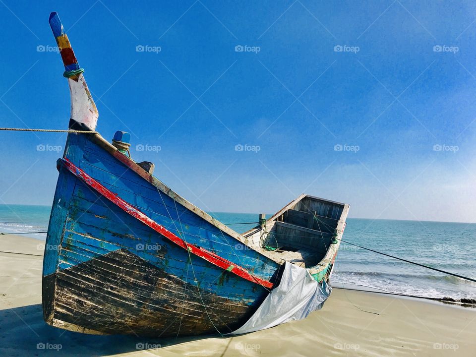 Adorable view of a Clear Blue Sky with Blue Ocean. Colourful Fishing boat on the seashore.                      Really a beauty of nature.... 😍