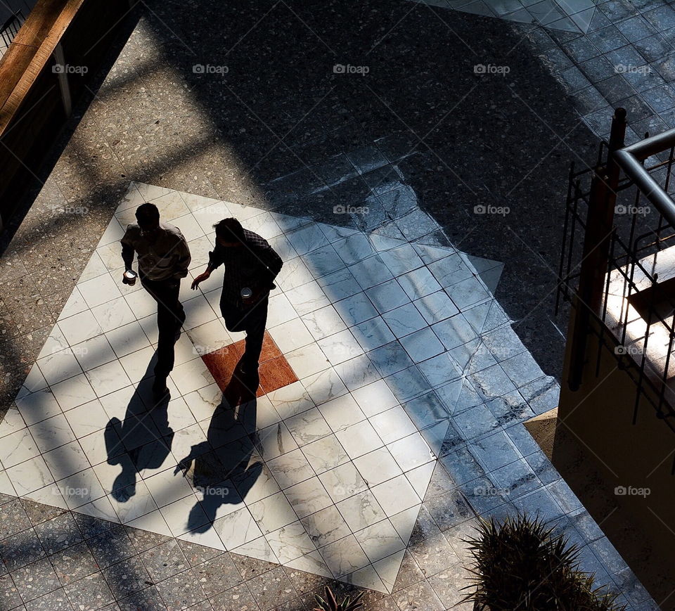 Shadow and silhouette of two men engaged in conversation