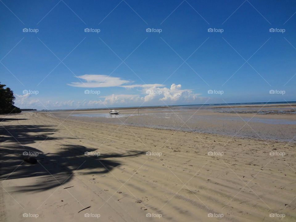 Idyllic view of a boat on the desert beach 