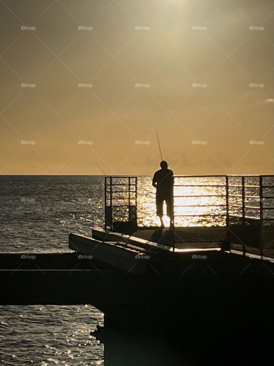Shade of a fisherman at sunset