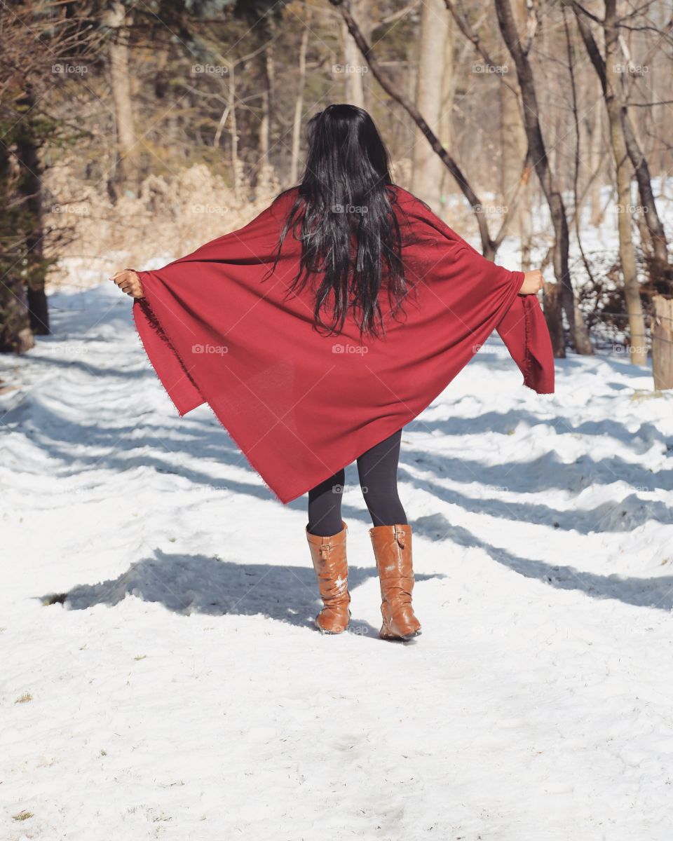 Young woman having walk in winter outdoors