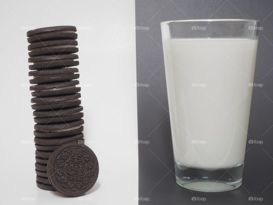 Oreo cookie black and white contrast glass of milk and stack of cookies