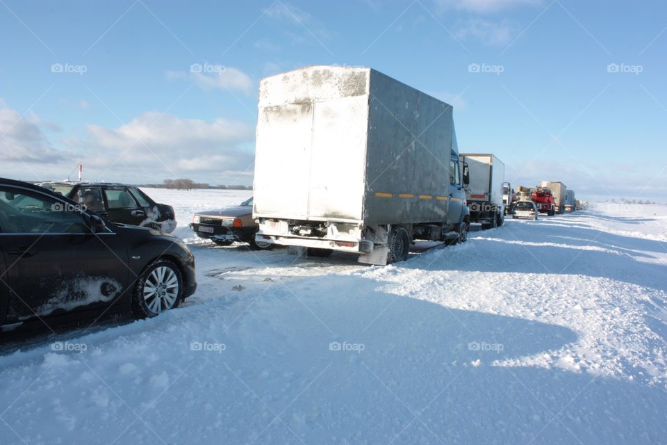 We with friends had our trip from Kyiv to Minsk for New Year celebration. While right before departing, an unusual amount of snow covered Ukraine. Moment of us being paralyzed in the middle of the highway and field with other cars.
