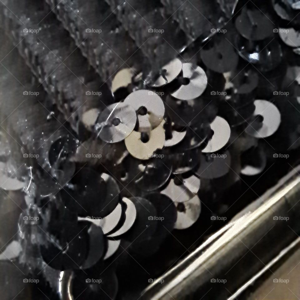 close up of a black sequined shiny ladies belt silver clasp