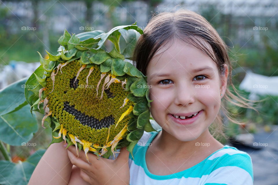 Smiling girl with sunflower