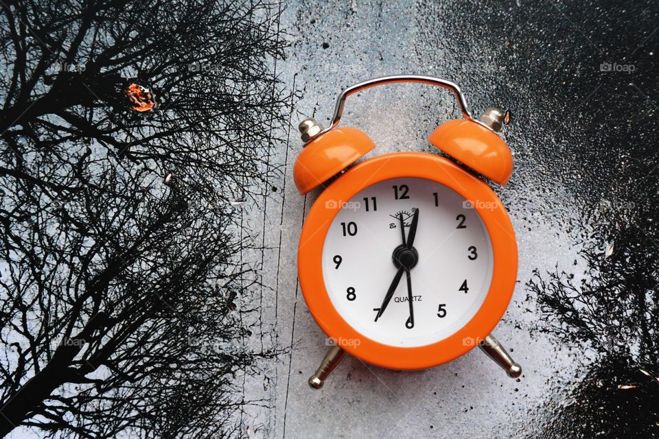 orange alarm clock black and white nature background