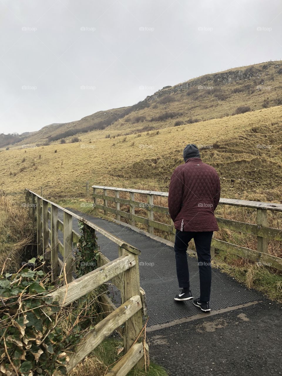 A man on an afternoon walk in Irish countryside 