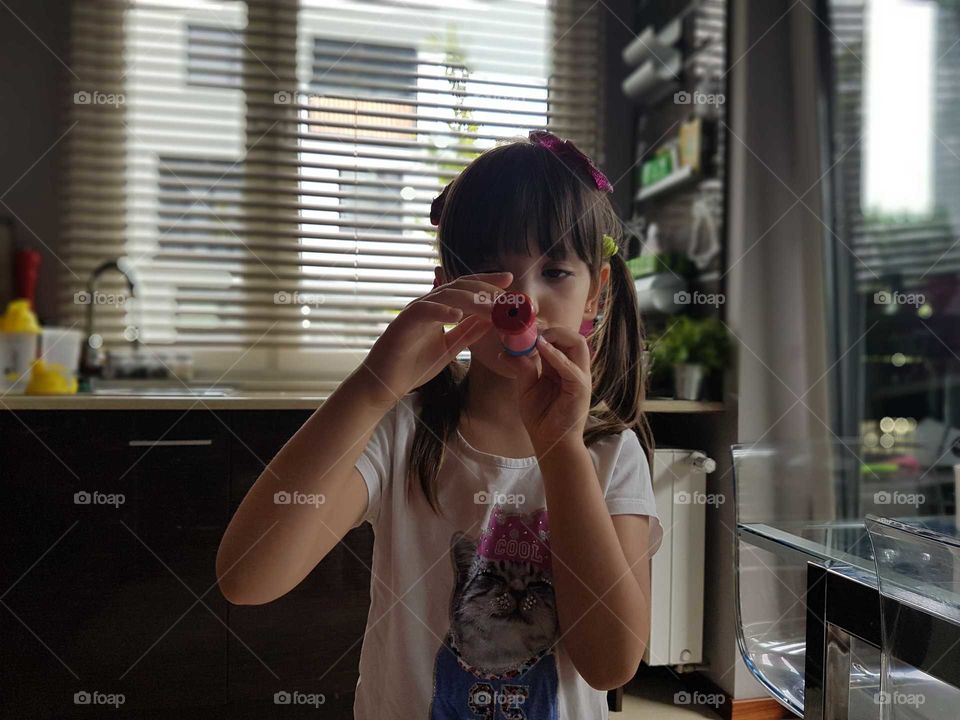 Litle girl playing on flute