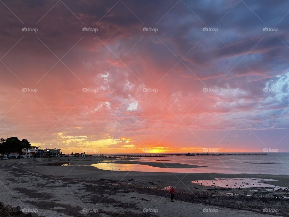 A sunset over a jetty 