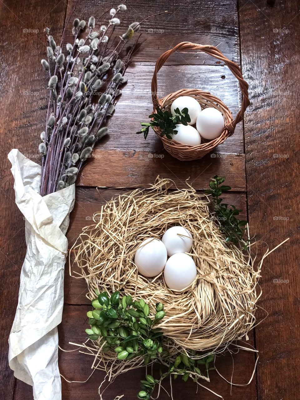 Easter composition of catkins and eggs on wooden table