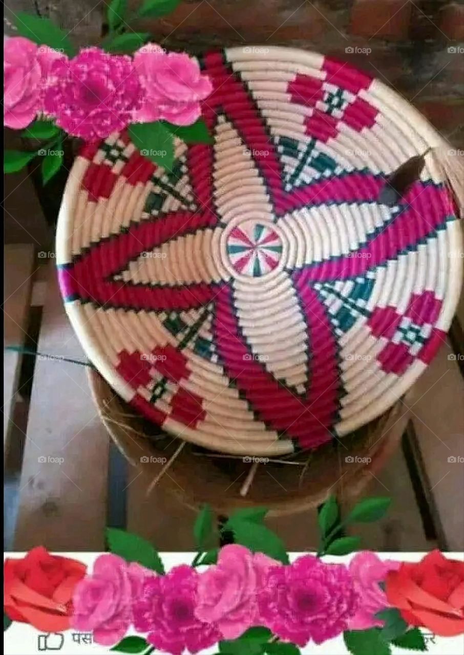 The image shows a group of hand -made dishes of wicker, decorated with colored embroideries with beautiful floral shapes, and is elegantly displayed in a warm corner that combines heritage and beauty, which gives the place an artistic spirit and attr