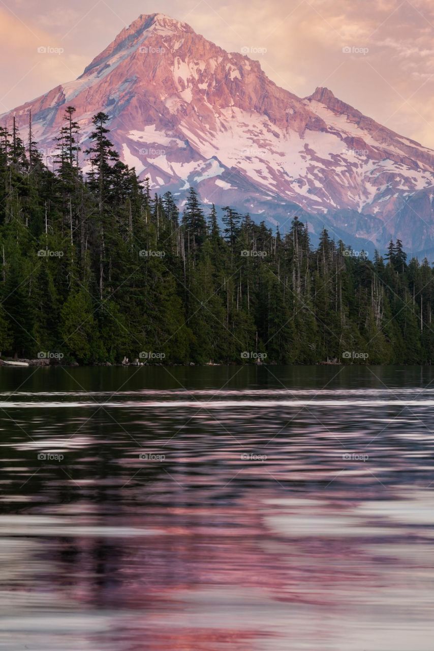 Mountain glowing in summer sunset light over lake in Oregon, Pacific Northwest United States