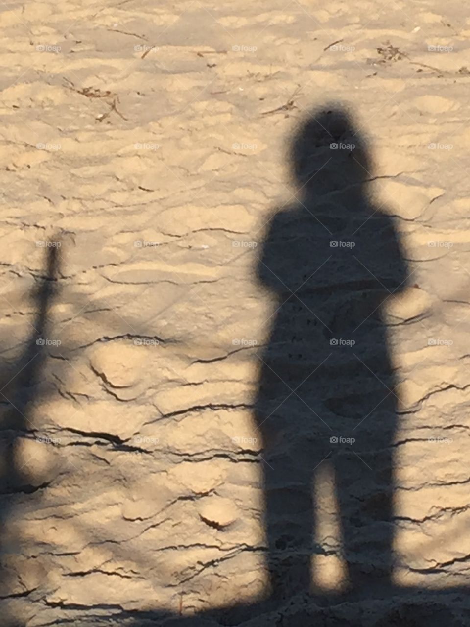 Shadows of girls in  sand