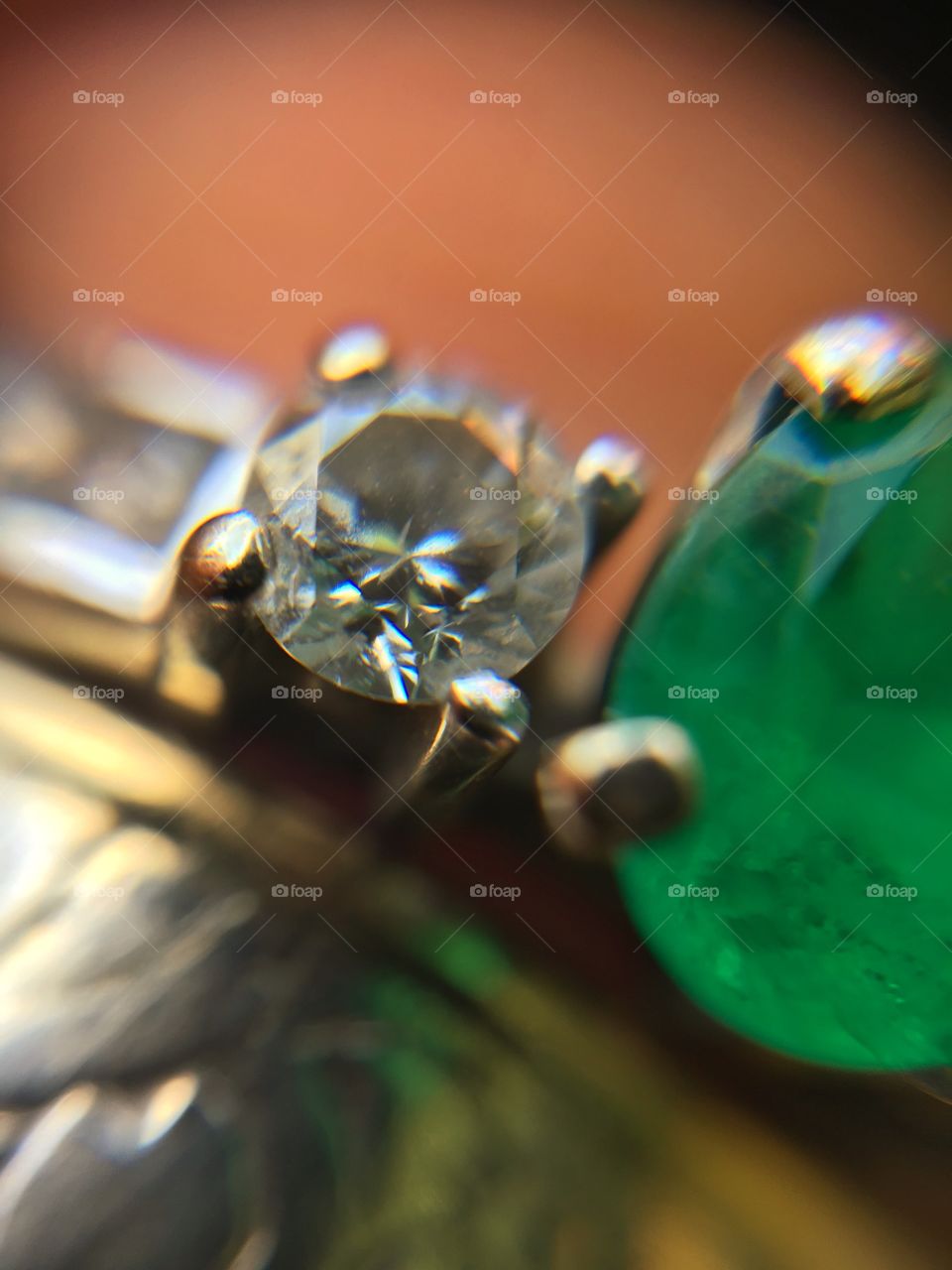 Close up of wedding ring with diamonds and emeralds