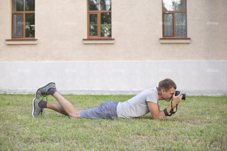 Man on the ground talking pictures