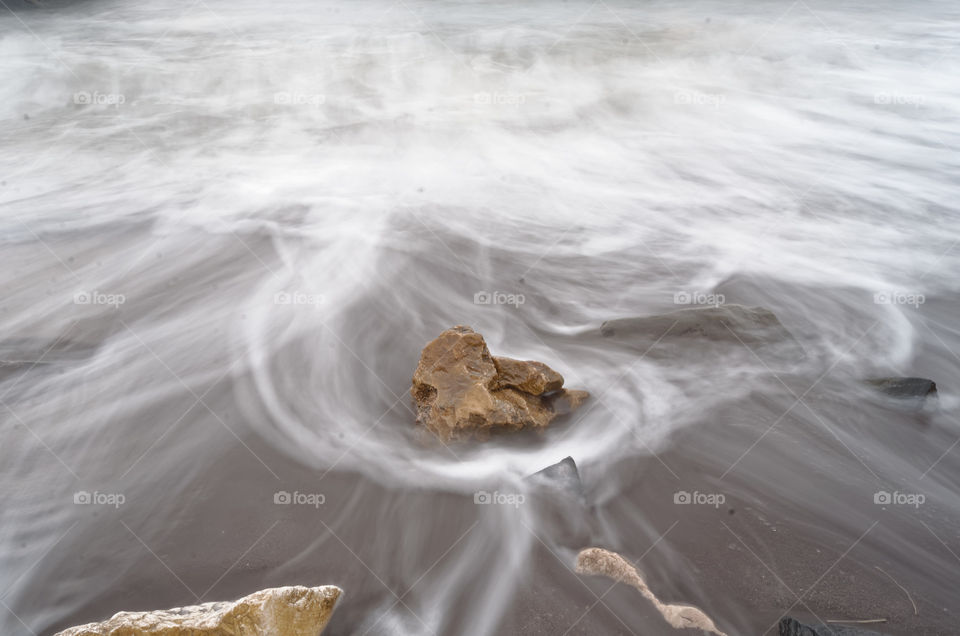 wavy waters. A long exposure shot of a beach landscape