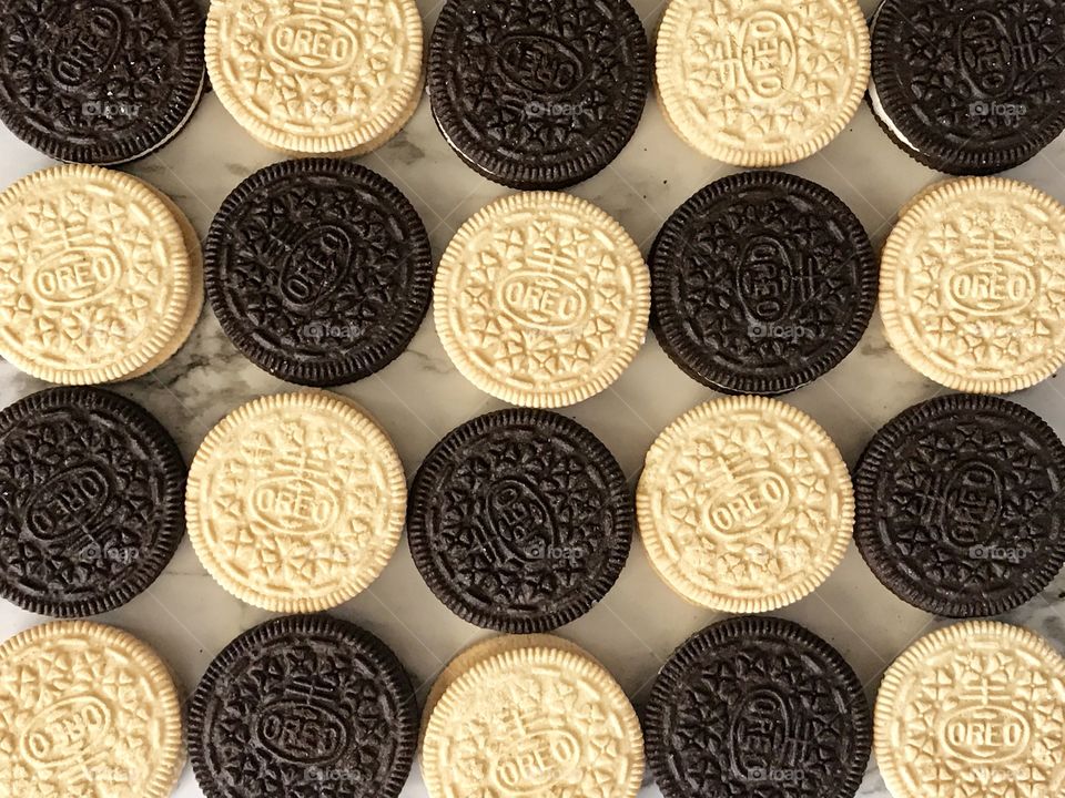 Golden and chocolate Oreo double stuff cookies contrasting Flatlay 