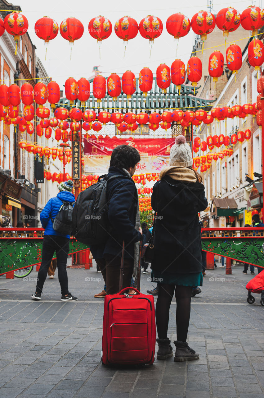 Couple of tourists admiring Chinese lanterns in Soho district in London. UK.