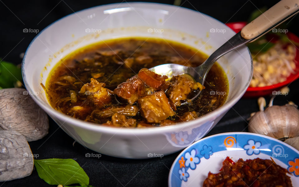 Having a delicious black beef soup 