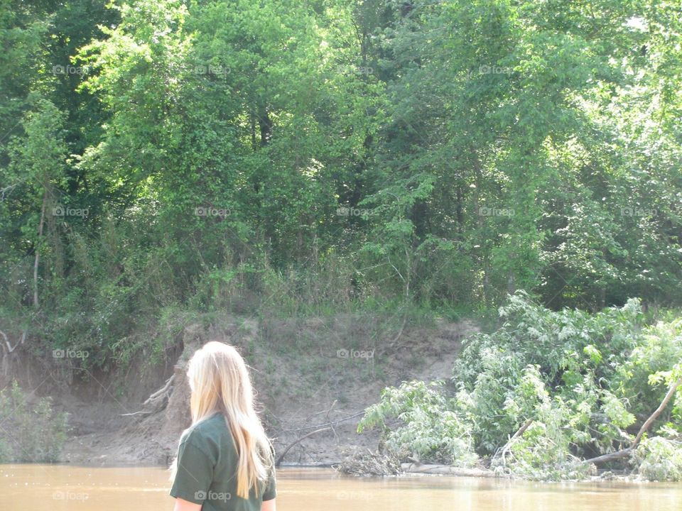 Blonde girl on the riverside 