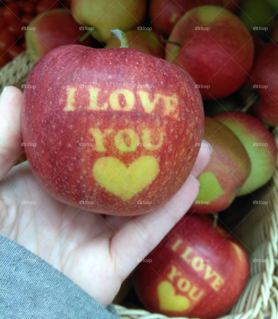 red apple i love you heart in hand fruits background